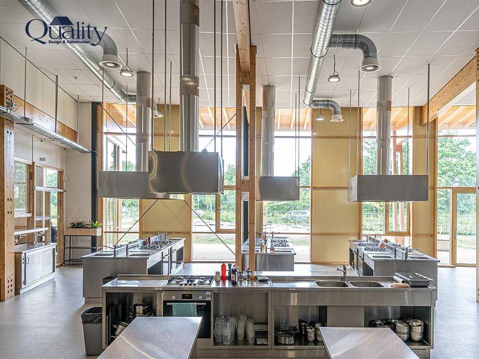 Bright well ventilated kitchen with a range hood over the cooktop