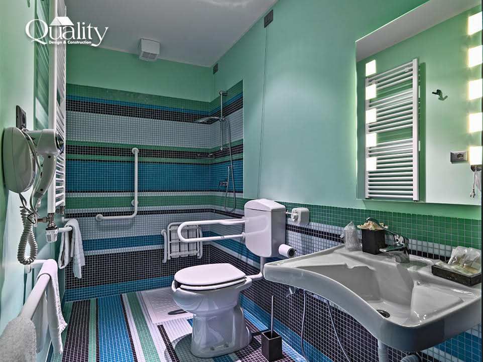 Accessible bathroom with grab bars and a curbless shower